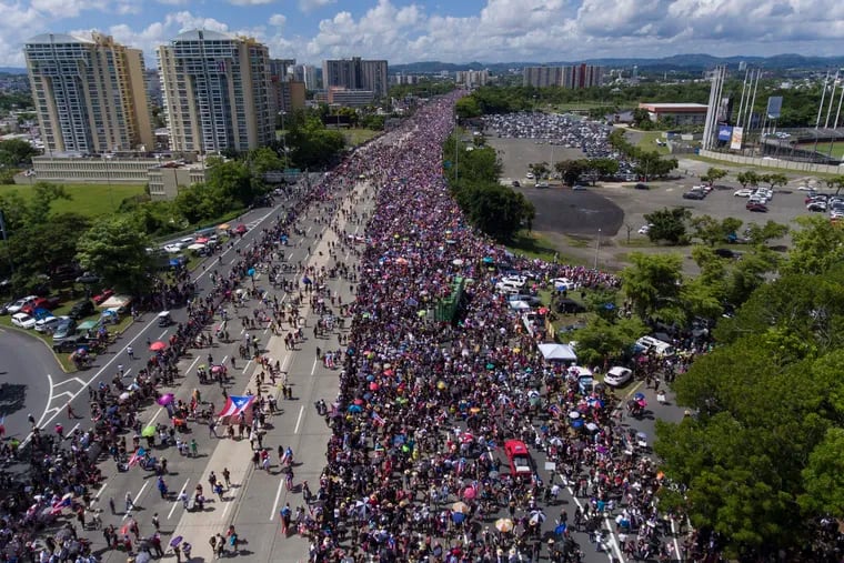 Demonstrators march on Las Americas highway demanding the resignation of governor Ricardo Rossello, in San Juan, Puerto Rico, Monday, July 22, 2019. Protesters are demanding Rossello step down for his involvement in a private chat in which he used profanities to describe an ex-New York City councilwoman and a federal control board overseeing the island's finance.