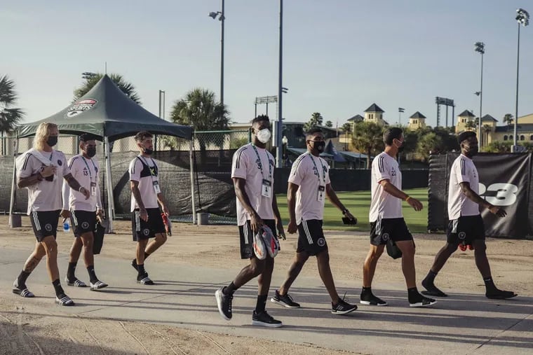Inter Miami players walk past one of the fields at Disney's Wide World of Sports Complex near Orlando, Fla., after a practice session on July 5.