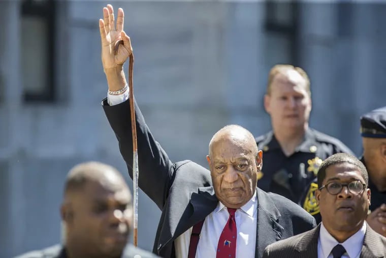 As Bill Cosby leaves the Montgomery County Courthouse, he raises his arm in recognition to the crowd noise as he makes his way to his SUV after being found guilty on all three counts of sexual assault during his retrial in Norristown, Pa., on Thursday, April 26, 2018.