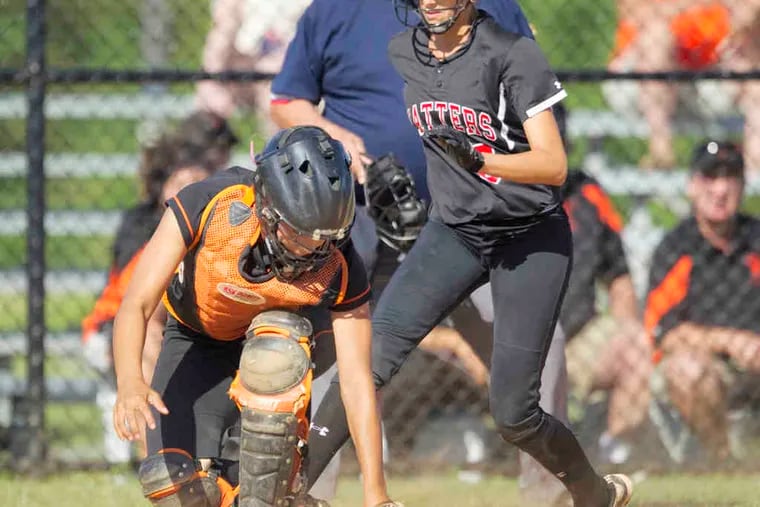 Pennsbury's catcher D'Anna Devine loses the handle on the ball as Hatboro-Horsham's Danielle DiFilippo scores. Two errors in the eighth aided the Hatters' efforts in the title victory.