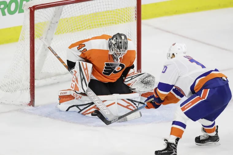 Flyers goaltender Anthony Stolarz stops the Islanders Jan Kovar in a preseason game. Stolarz was sent to the Phantoms on Saturday and replaced with Cal Pickard.