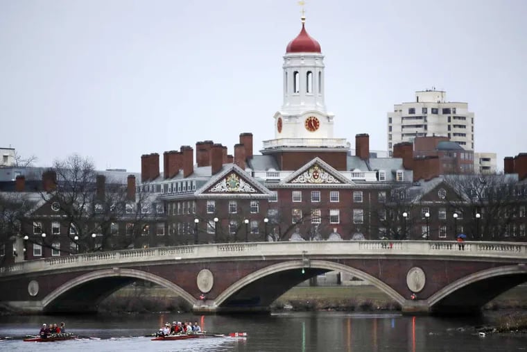 In this March 7, 2017 file photo, rowers paddle along the Charles River past the Harvard campus in Cambridge, Mass.