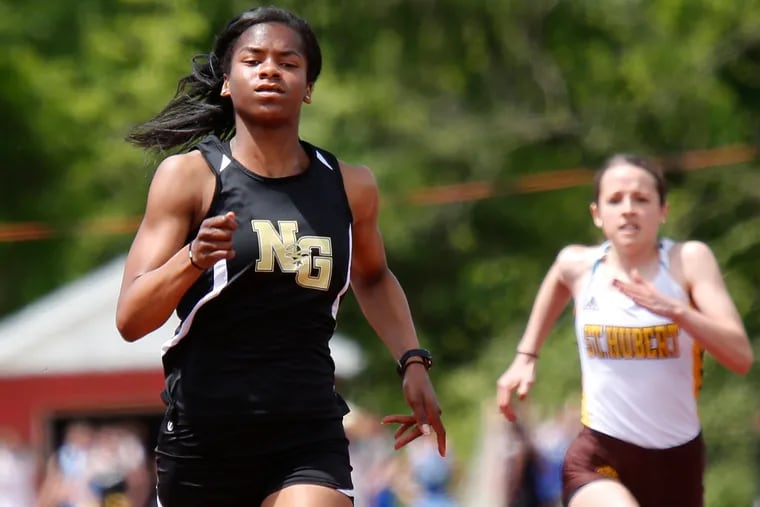 Mykala Perry (left) of Neumann-Goretti runs to victory in the 100 meters in 12.73 seconds at the Catholic League track and field championships Saturday, May 11, 2019 at Cardinal O'Hara. LOU RABITO / Staff