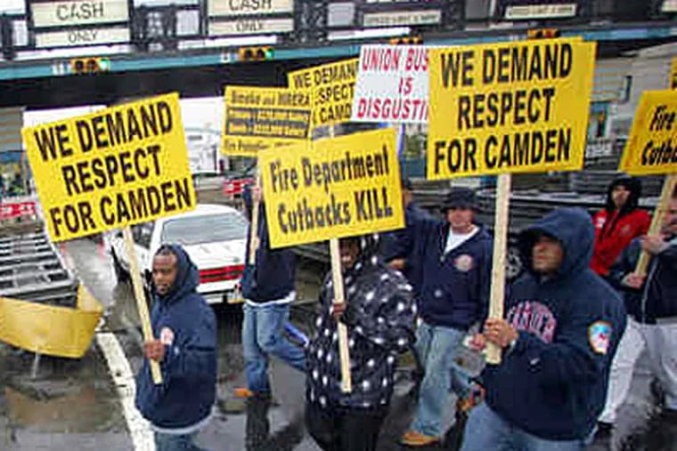 Camden firefighters block traffic at the Ben Franklin tolls. The workers were angry at cutbacks and other policies imposed by the city's state-appointed chief operating officer, Theodore Z. Davis. (DAVID SWANSON / Staff Photographer)