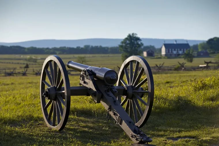 At sunset on the Gettysburg Battlefield, a Union cannon points toward the field where Confederate troops launched Picketts Charge in July 1863, in Gettysburg.