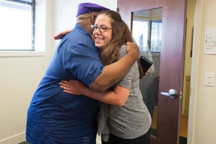 Jodi Savits, who directs Fresh Start transitional housing and supportive services for male veterans with drug and mental health issues at the Coatesville Veterans Affairs Medical Center, gets a hug from Army combat vet Jeffrey R. Jones, who affectionately calls her his “Mom Dukes.”
