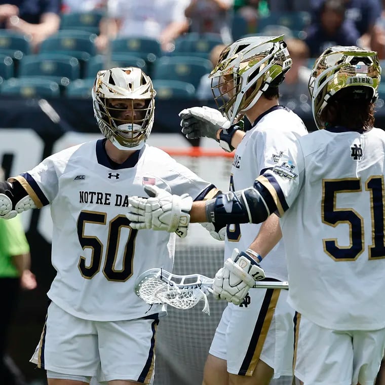 Notre Dame attackman Chris Kavanagh (left) celebrates his first period goal with teammates midfielder Will Angrick (center) and attackman Pat Kavanagh against Denver.
