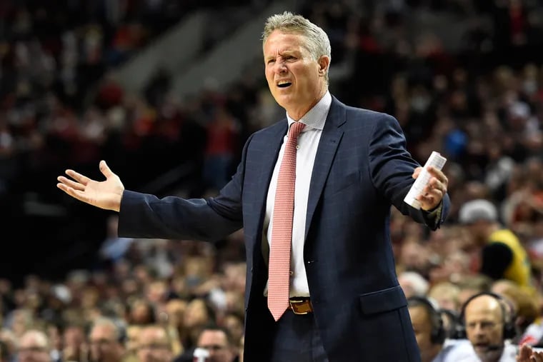 Philadelphia 76ers coach Brett Brown reacts to an official's call during the fourth quarter of the team's NBA basketball game against the Portland Trail Blazers in Portland, Ore., Saturday, March 26, 2016. The Blazers won 108-105.