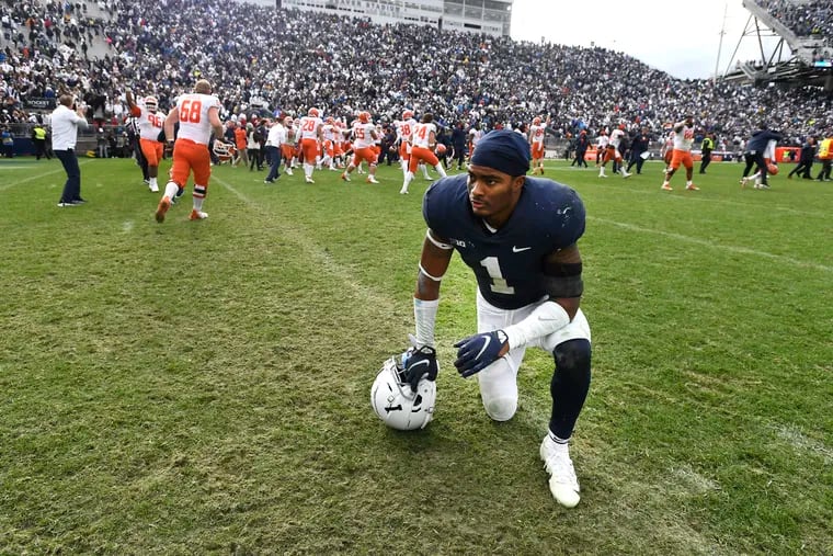 Penn State safety Jaquan Brisker reacts as Illinois players celebrate their 20-18 victory in the ninth overtime Saturday.