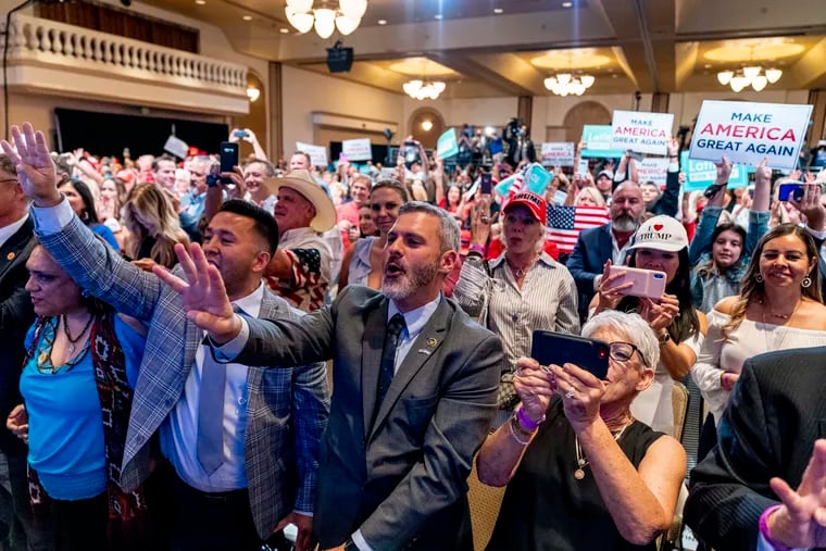 Supporters react as President Donald Trump speaks at a Latinos for Trump Coalition roundtable at Arizona Grand Resort & Spa in Phoenix in September.