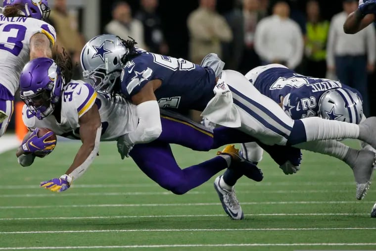 Vikings running back Dalvin Cook (33) is tackled by Cowboys middle linebacker Jaylon Smith (54) in the second half of their game on Sunday.