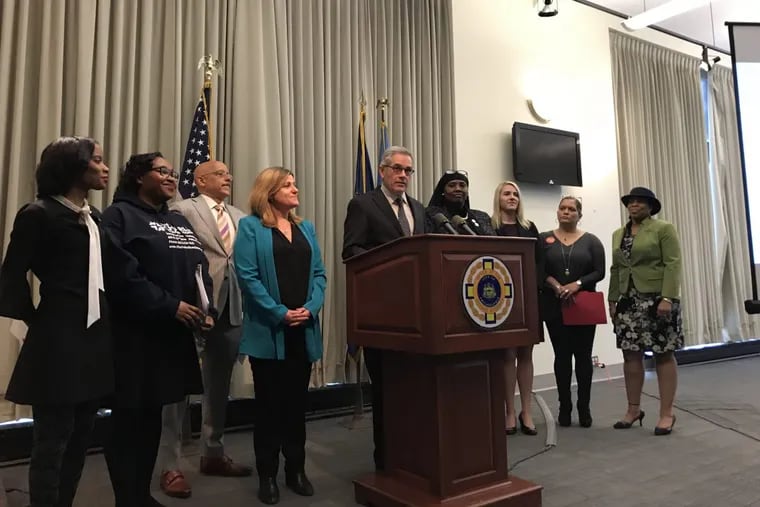 Philadelphia District Attorney Larry Krasner, flanked by supporters and advocates, announces creation of a committee for crime victims on April 6, 2018.