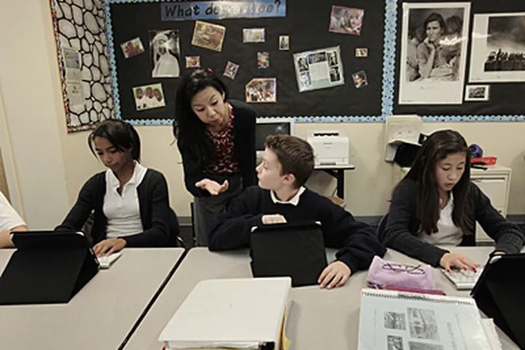 Christina Pak, center left, has her students use iPads during a history lesson at Hillbrook School in Los Gatos, Calif. Also pictured are seventh-grade students Jacqueline Vaughn, from left, Curtis Lloyd and Maya Mizuki. (Gary Reyes/San Jose Mercury News/MCT)