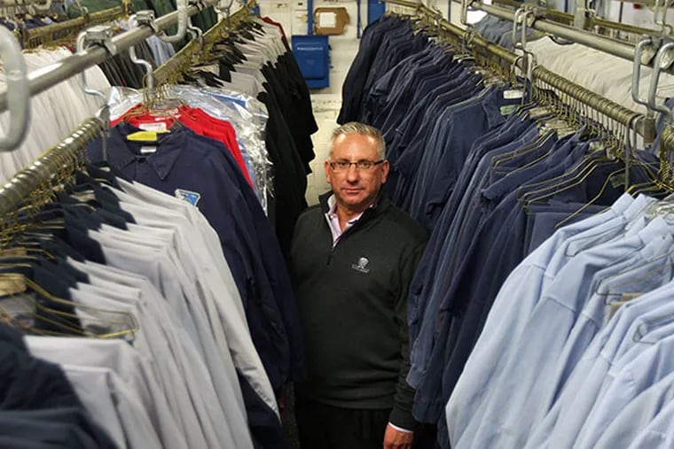 Jim Wasserson, CEO of Clean Rental, a leading independent uniform rental company that services thousands of workforces, poses with some of the uniforms at his factory in Philadelphia, Pa. on February 10, 2014. ( DAVID MAIALETTI / Staff Photographer )