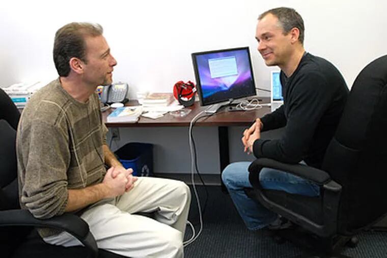 Chariot Solutions CEO Michael Rappaport (left) chats with software architect Matt Swartley in the company's Fort Washington office.