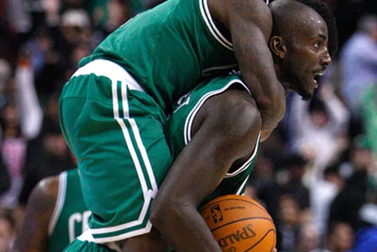 Celtics Kevin Garnett celebrates after he hit the game winner as Nate Robinson jumps on his back. (Ron Cortes/Staff Photographer)