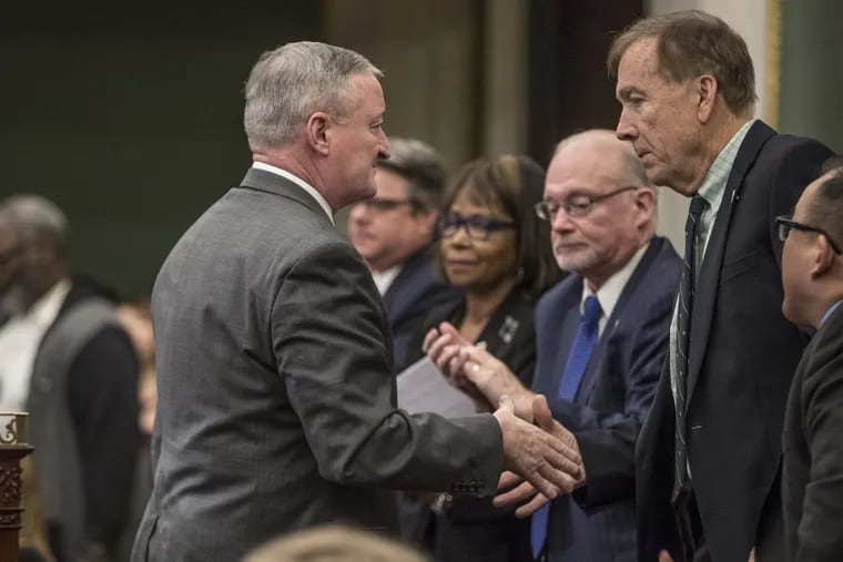 Mayor Kenney, left, turns to shake Councilman Brian J. O’Neill’s hand after giving his budget address on March 1.