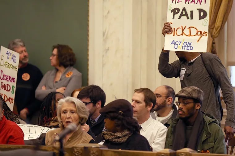 Marvin Robinson, of West Philadelphia, holds up a sign during a City Council public hearing on the paid sick leave bill on Feb. 3, 2015. ( DAVID MAIALETTI / Staff Photographer )