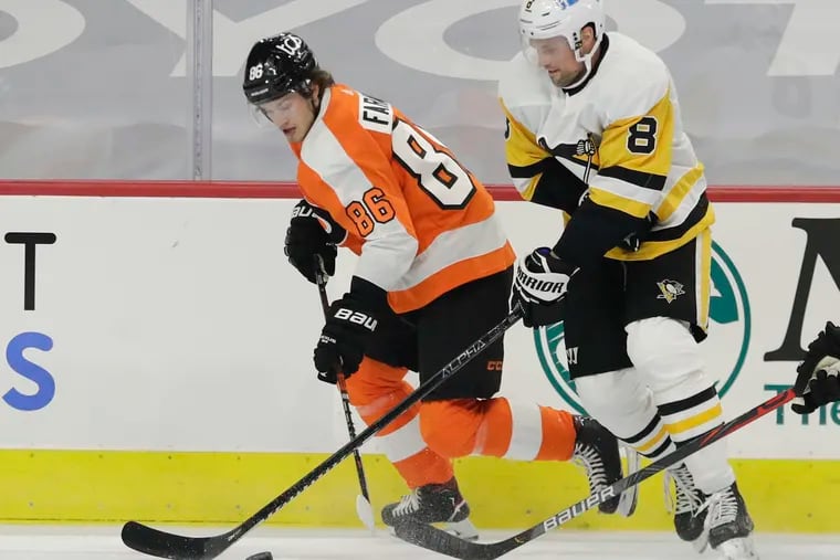 Flyers right winger Joe Farabee, who had a career-high four points Wednesday, skates past Pittsburgh Penguins defenseman Brian Dumoulin in the season opener. The Flyers won, 6-3.