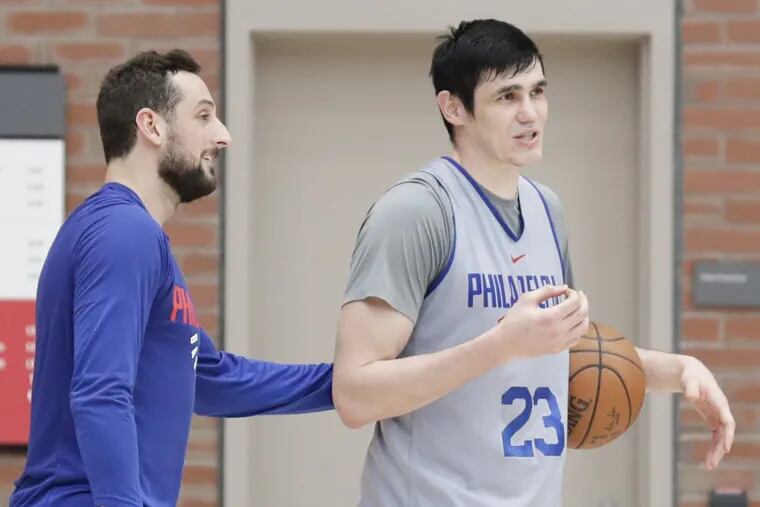 The Sixers’ Ersan Ilyasova (left) with teammate Marco Belinelli after practice Wednesday. Both struggled off the bench in Game 1.