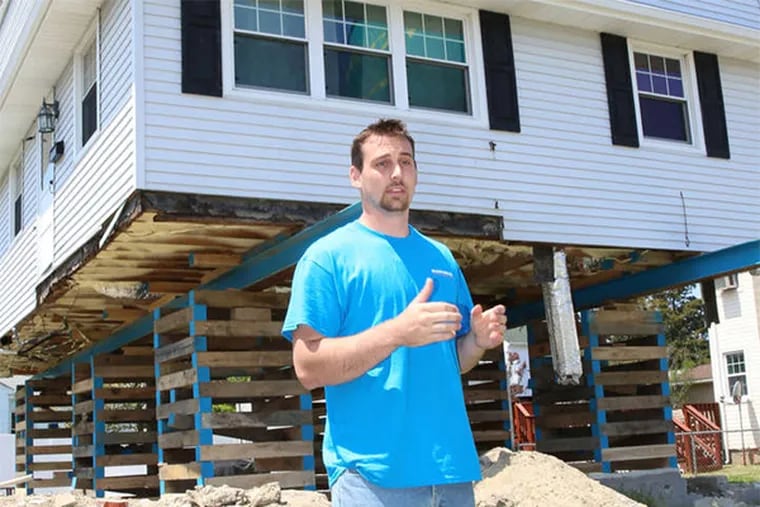 Andrew Baumgardner lifting a Ventnor Heights house. After seeing the storm damage, he quit college to start a house-lifting service.