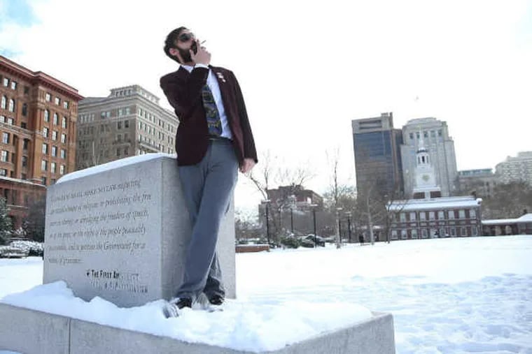 Marijuana activist N.A. Poe, whose real name is Richard Tamaccio Jr.,  smokes a joint on Independence Mall in February 2015. Poe and 21 others were arrested April 22 when police busted a marijuana party he organized in Frankford.