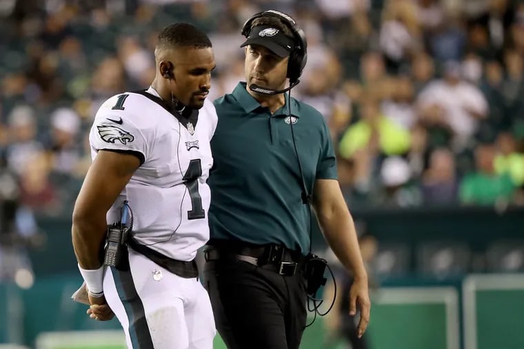 Eagles quarterback Jalen Hurts talking with head coach Nick Sirianni during the second quarter against the Steelers.
