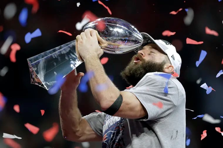 The Patriots' Julian Edelman holds the trophy after the Super Bowl LIII victory over the Rams.