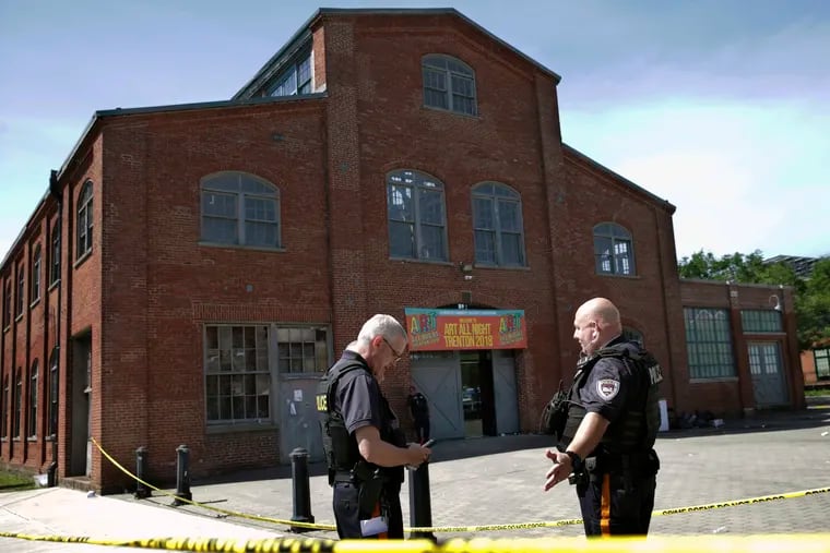 Police stand guard outside the warehouse building where the Art All Night 2018 festival was held in Trenton last June.