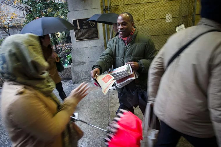 Jay Johnson, volunteer coordinator with ActionAIDS, was among about 20 volunteers distributing a World AIDS Day tabloid to commuters at City Hall.