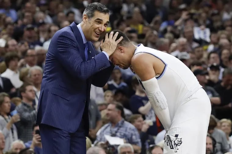 Villanova head coach Jay Wright embraces star guard Jalen Brunson toward the end of the Wildcats’ 79-62 win over the Michigan Wolverines in the NCAA men’s basketball championship game.