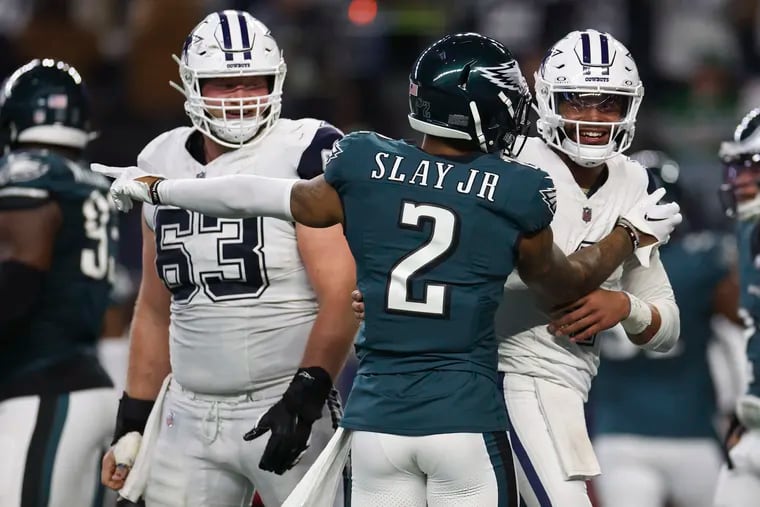 Cowboys quarterback Dak Prescott laughs as the Eagles' Darius Slay points to a flag that was thrown on a Dallas touchdown during the second quarter Sunday. No penalty was called.