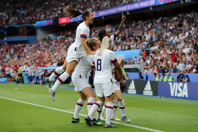 Megan Rapinoe of the USA celebrates with teammates after scoring her team's first goal during the 2019 FIFA Women's World Cup France Quarter Final match between France and USA at Parc des Princes on June 28, 2019 in Paris, France. (Elsa/Getty Images/TNS) **FOR USE WITH THIS STORY ONLY**