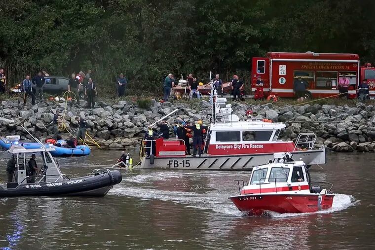 Emergency personnel, including divers, search the Chesapeake and Delaware Canal after a car with five people aboard crashes into the shipping channel.