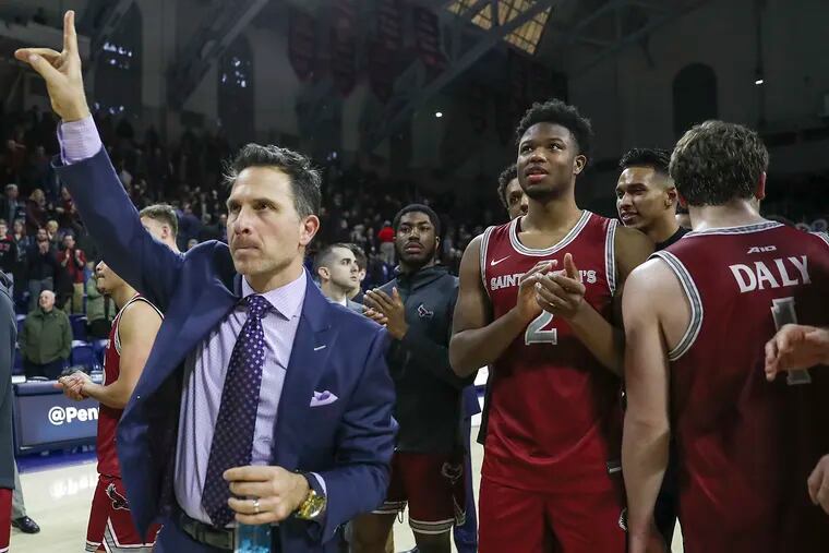 Saint Josephs head coach Billy Lange acknowledges the fans after his team defeated Penn at the Palestra in Philadelphia on Saturday, Jan. 18, 2020. Saint Josephs won, 87-81.