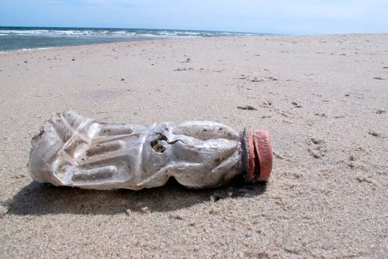 A discarded plastic bottle lies on the beach at Sandy Hook, N.J. on Tuesday, April 2, 2019, the same day as a report released by the environmental group Clean Ocean Action found that volunteers picked up more than 450,000 pieces of litter from New Jersey's coastline last year. (AP Photo/Wayne Parry)