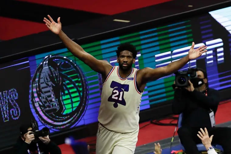 Sixers center Joel Embiid raised his arms after beating the Los Angeles Clippers on April 16 in Philadelphia.