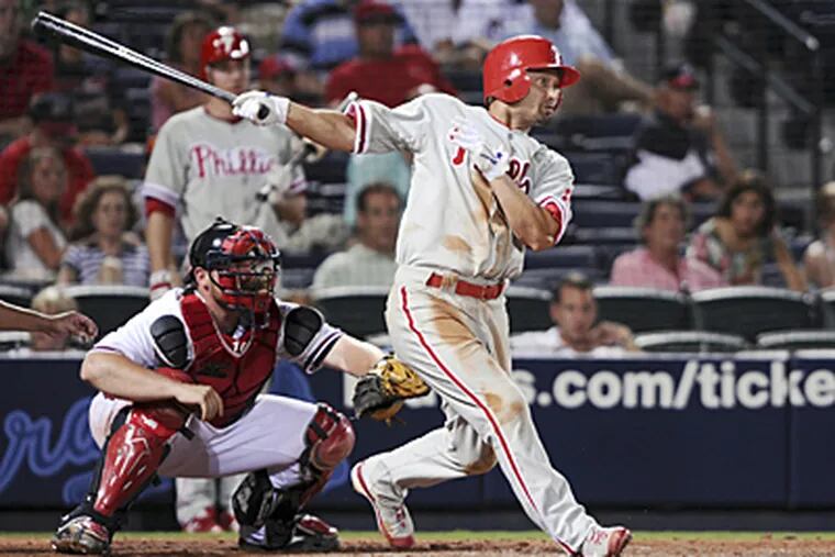 Philadelphia Phillies center fielder Shane Victorino hits an RBI triple as Atlanta Braves in the 10th inning at Turner Field on Friday. The Phils beat the Braves 4-3. (AP)