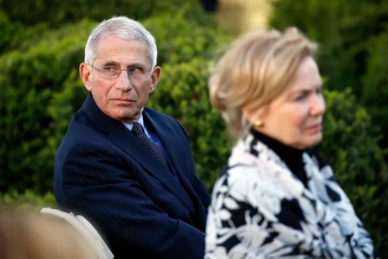 Dr. Anthony Fauci, director of the National Institute of Allergy and Infectious Diseases, and Dr. Deborah Birx, White House coronavirus response coordinator, listen as President Donald Trump speaks about the coronavirus in the Rose Garden of the White House.