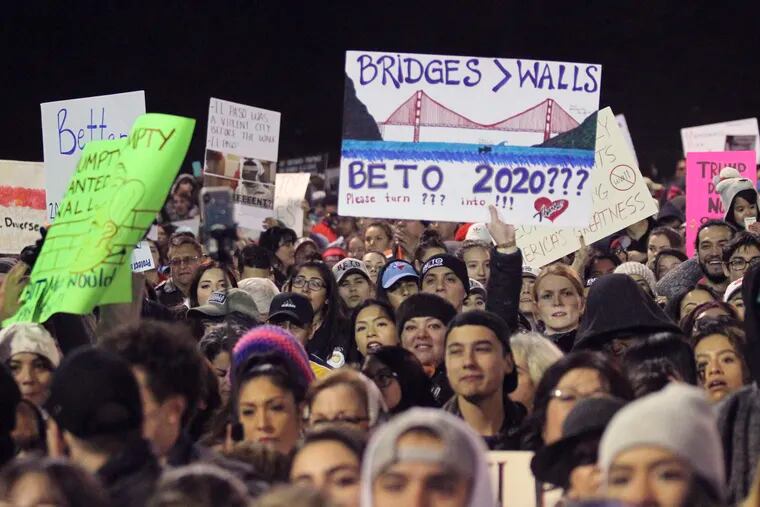 People attend an outdoor rally for former U.S. Rep. Beto O'Rourke outside the El Paso County Coliseum where President Donald Trump was holding a rally in El Paso, Texas, Monday, Feb. 11, 2019.