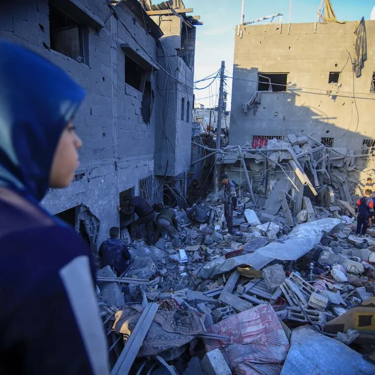 Palestinians search the rubble of a destroyed building following an Israeli airstrike in the Nuseirat refugee camp, central Gaza, on Wednesday.