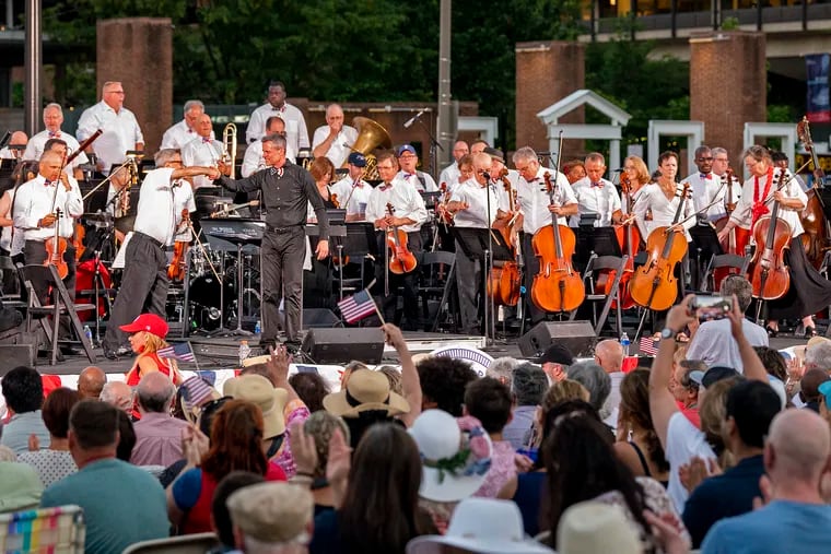 Philly Pops music director David Charles Abell (right) and concertmaster Michael Ludwig (left) onstage on Independence Mall, July 3, 2022, at the conclusion of the Pops's traditional Independence concert.