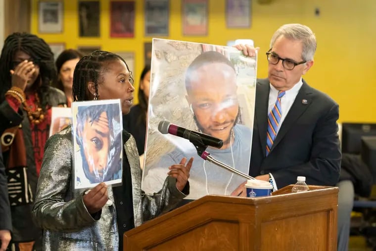 Markiya Jackson (front left) holds a photo of sibling Mar’Quis "MJ" Jackson, while speaking at a news conference with District Attorney Larry Krasner, holding another photo of Mar’Quis "MJ" Jackson, at GALAEI on March 15.