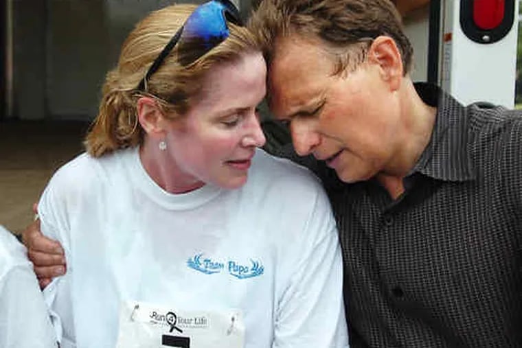 Gary Papa embraces wife Kathleen after she ran in the annual Father's Day 5K run benefiting cancer research last year.