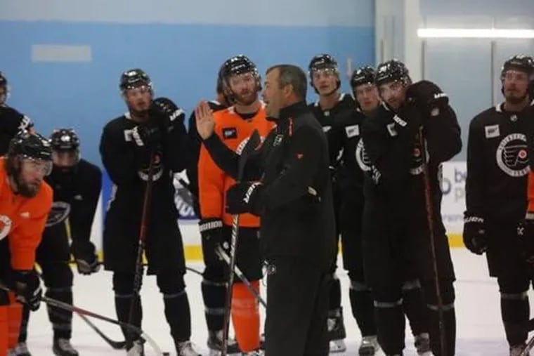 Flyers coach Alain Vigneault gives instructions during Monday's practice in Toronto.