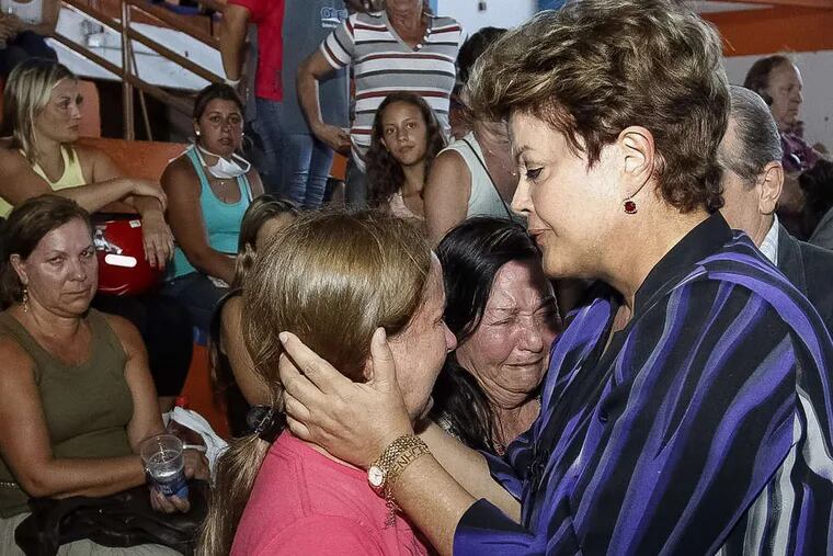 Brazilian President Dilma Rousseff comforts victim's relatives in Santa Maria on Sunday, after the blaze considered the deadliest in more than a decade at a club.