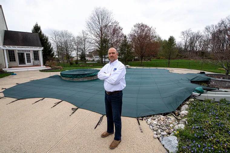 Tom Casey, vice president of sales at Anthony and Sylvan Pools, near his own pool in Ivyland, Bucks County.