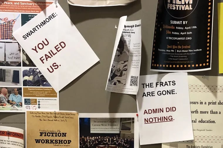 Signs hang on the bulletin board at Parrish Hall, Swarthmore College's administration building.