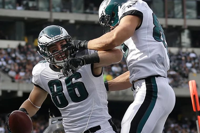 Eagles tight end Zach Ertz (86) celebrates with tight end James Casey after Ertz caught a 15-yard touchdown during the second quarter of an NFL football game against the Oakland Raiders in Oakland, Calif., Sunday, Nov. 3, 2013. (Marcio Jose Sanchez/AP)