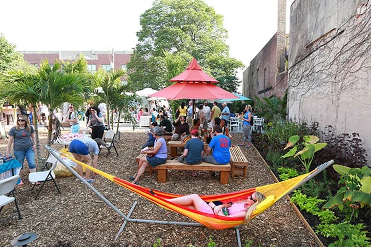 Jordan Price relaxes at the Pop Up Garden at 1438 South St. Tuesday, July 8, 2014. Proceeds from the Pop Up Garden support PHS City Harvest, which creates green jobs and brings together a network of community gardeners, who grow fresh, healthy produce for families in need.